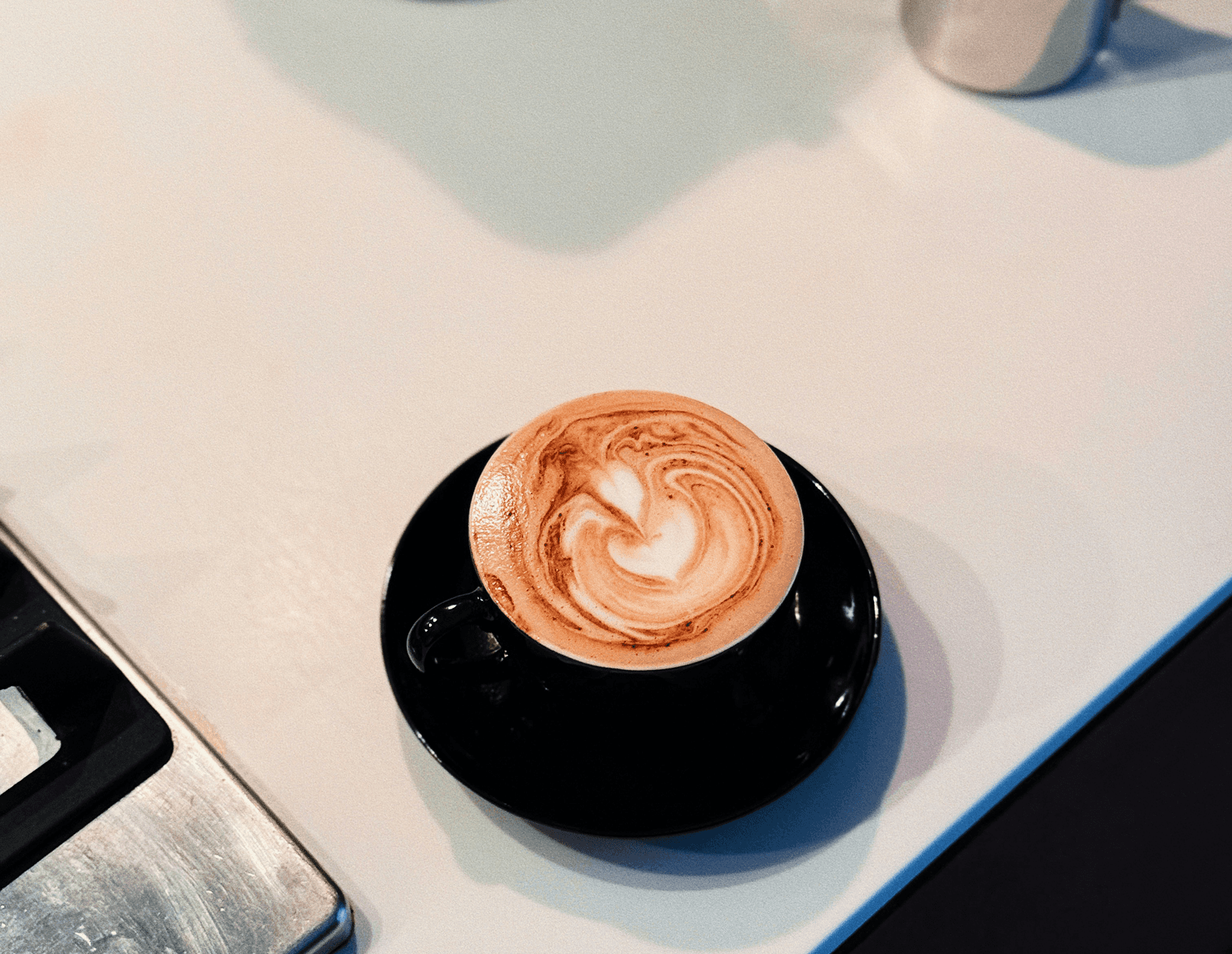 Latte art in black cup
