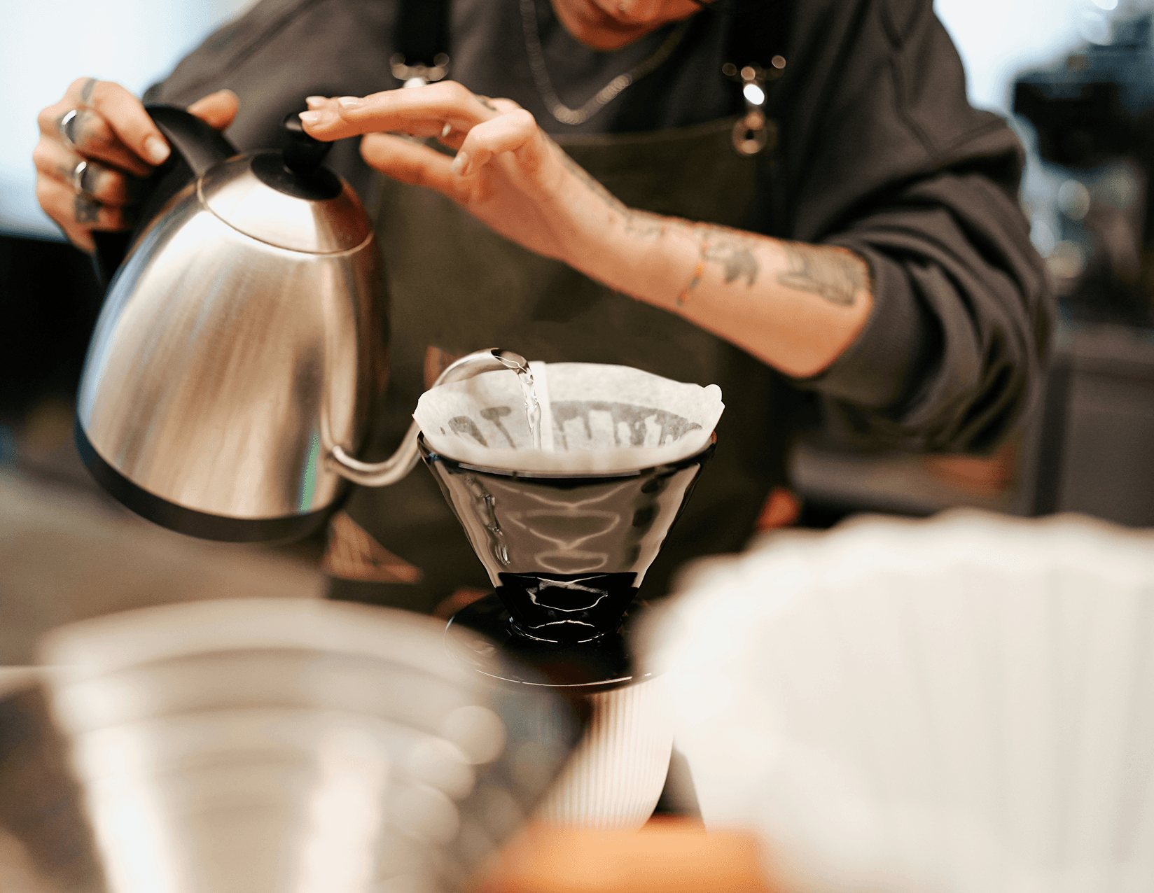 Barista pouring hot water